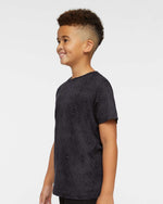 Load image into Gallery viewer, Three-quarter profile view of a young boy wearing the Black Reptile t-shirt, highlighting the sleeve length and subtle snakeskin print design.