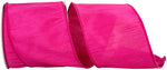 Load image into Gallery viewer, A partial, loose curl of the 4-inch wide Dupioni Supreme Wired Edge Ribbon, highlighting its solid vibrant fuchsia color, slubbed fabric texture, and a matching stitched wire edge."