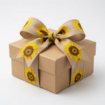 Load image into Gallery viewer, A square kraft gift box topped with a beautifully structured, multi-loop bow styled from the natural sunflower linen wired ribbon.
