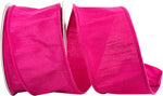 Load image into Gallery viewer, A partial, loose curl of the 2.5-inch wide Dupioni Supreme Wired Edge Ribbon, highlighting its solid vibrant fuchsia color, slubbed fabric texture, and a matching stitched wire edge.
